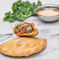 Ratatouille Empanada · Onions, tomatoes, green and red peppers, zucchini, and eggplant.
