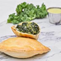 Spinach Empanada · Vegan friendly. Spinach, garlic, onions, mozzarella, and Parmesan cheese.
