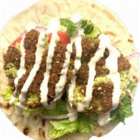 Falafel Wrap · Flavorful Falafels in a wrap with creamy hummus, crispy romaine, diced tomatoes, sumac onion...