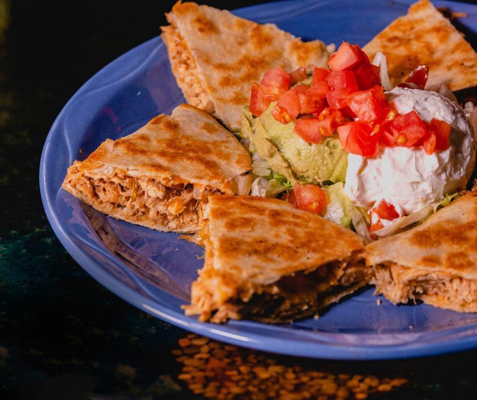 Chicken Quesadilla · A large flour tortilla grilled to a perfect crisp. Filled with cheese, tomatoes, black olives and green peppers. Served with lettuce, tomato, sour cream and guacamole. Substitution shredded beef and ground beef for an additional charge.