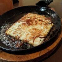 Saganaki - The Flaming Cheese · Pan seared feta cheese with olive oil, flamed tableside with brandy and lemon juice. Served ...