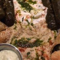 Mezza Platter · Combination appetizer of hummus, baba ganoug, dolmas, tzaziki, spanakopita and falafel nugge...