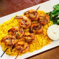 Shrimp Kebab · 2 grilled shrimp skewers, topped with lemon garlic aioli. Served with rice pilaf and Greek s...