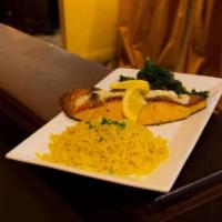 Grilled Salmon · Sustainable pacific farm raised salmon over sauteed greens, topped with citrus beurre blanc....