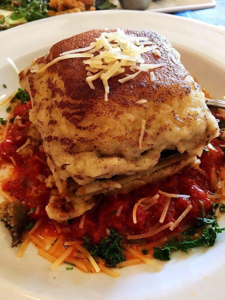 Greek Moussaka · Baked layers of eggplant, tomatoes, ground beef and potatoes topped with bechamel sauce.
