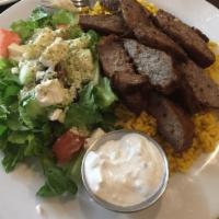 Gyro Plate · Roasted lamb and beef seasoned with Greek spices served over rice pilaf with a Greek salad.
