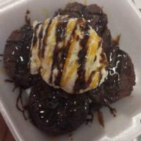 Brownie Lover · Brownie topped with vanilla ice cream chocolate, caramel drizzle on top. Topped with powdere...