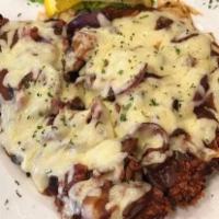 Alpen Schnitzel · Tender pork cutlet hand-breaded and pan fried golden brown and topped with mushroom gravy an...