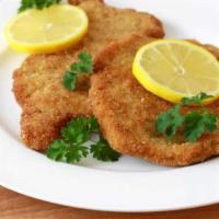 Wiener Schnitzel · Tender pork cutlets pan fried and served with lemon slices, sautéed red potatoes  and vegeta...