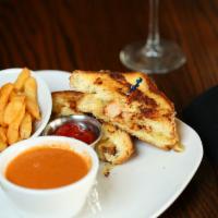 Lobster Grilled Cheese Sandwich · lobster, dill Havarti cheese, roasted garlic aioli on Texas toast served with roasted tomato...