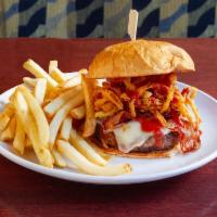 American Cowboy Burger · Flame grilled burger with crisp bacon, lettuce, tomato, sweet BBQ sauce, topped with Cajun o...