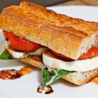 Caprese Sandwich · Sliced Buffalo mozzarella, basil, Roma tomatoes, baby greens, balsamic reduction on french b...