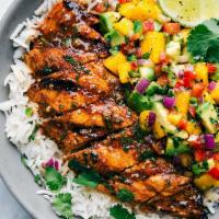 Carribean Grilled Chicken · Grilled jerk marinated chicken, topped with pineapple mango salsa, with house rice and seaso...