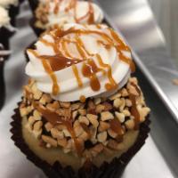 Chocolate Caramel Drum Cupcake · Vanilla cake topped with our fudge frosting, buttercream, nuts and caramel sauce.