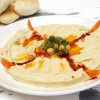 Hummus · Pureed chickpeas blended with olive oil, lemon juice, tahini and garlic. Vegetarian and glut...