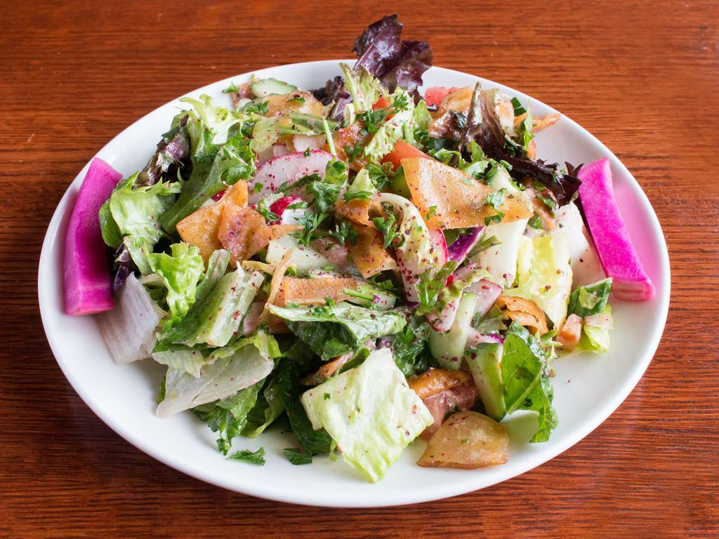 Fattoush Salad · A fresh mix of cucumbers, tomatoes, radish, cabbage, pita chips and Romaine lettuce tossed in homemade sumac vinaigrette dressing.  Vegetarian.