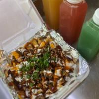 Loaded Jerk Fry · French fries with jerk chicken, nacho cheese, ranch, spicy, or sweet jerk sauce, and chives.