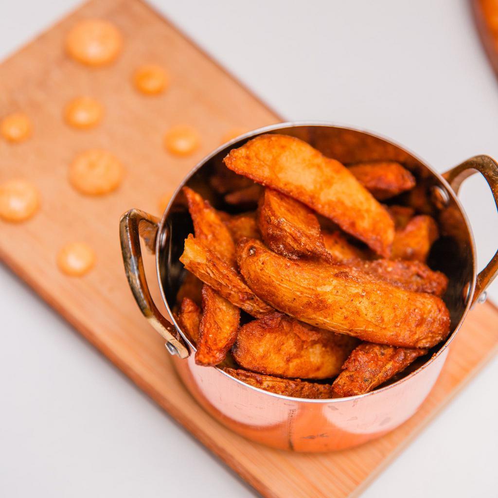Masala Fries · House made potato wedges with fresh ground spices and herbs. Served with your choice of dipping sauce