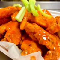 Chicken Wings · 1 dozen jumbo wings. Served with celery and blue cheese or ranch dressing.