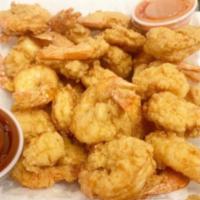 Shrimp by the Pound · Jumbo shrimp, fried, and served with fries and cocktail sauce.

