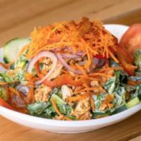Buffalo Chicken Salad · Buffalo-style chicken, fresh romaine, cucumbers, carrot threads, tomatoes, croutons, red pep...