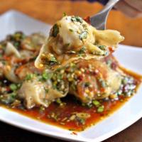 Dumpling In House Sauce · 6 steamed gyoza stuffed with pork, onion and cabbage in the house soy sauce.