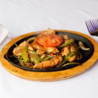 Chicken Fajita · Marinated sizzling strips of chicken topped with sauteed onions, peppers and mushrooms serve...