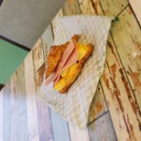 Egg, Ham and Cheese Sandwich · Homemade croissant with chipotle mayo, egg, ham and cheddar cheese, along with a hashbrown.