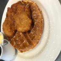Chicken & Waffles · Housemade belgian waffle topped with crispy boneless chicken breast. Side of warm maple syrup.
