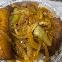Bistec Encebollado · Steak with onions, rice, beans, and sweet plantain.