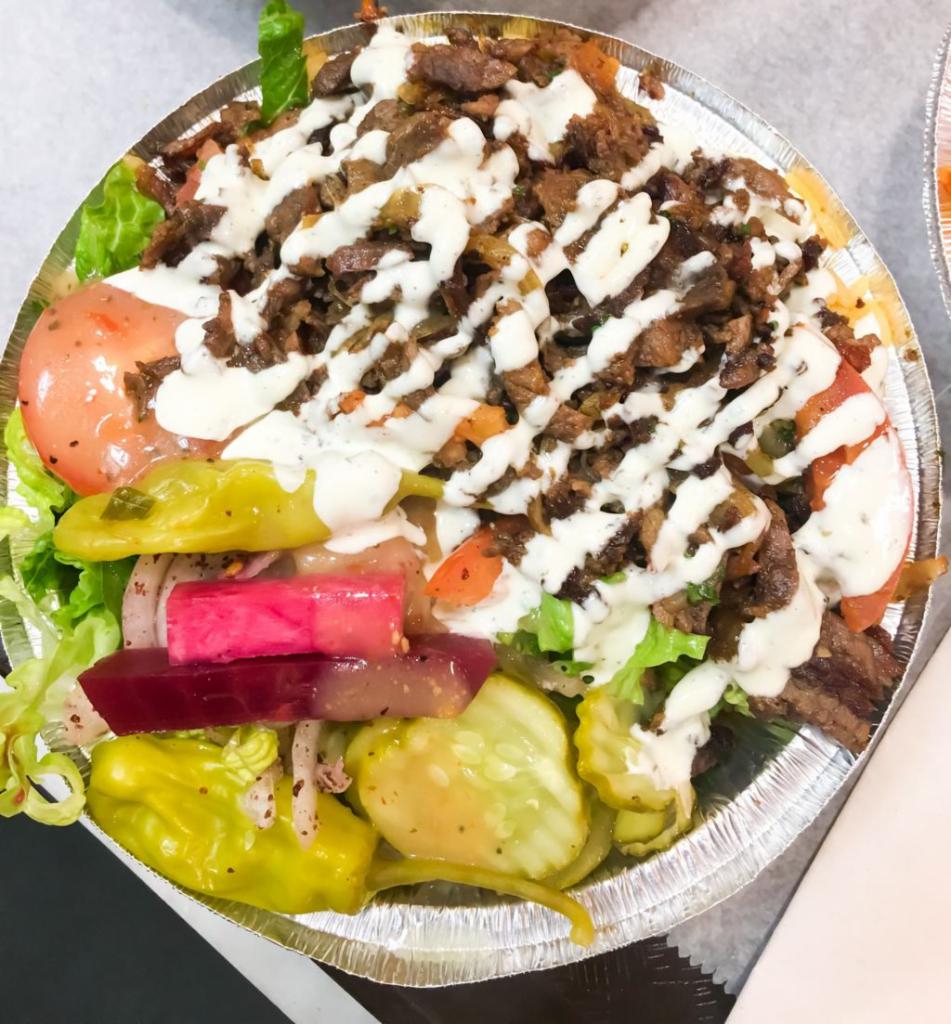 Lamb & Beef Shawarma Large Bowl · Thinly sliced flame roasted lamb & beef. Served with rice, salad (lettuce, pickles, turnip, beets, onions), 3 side sauces and pita.