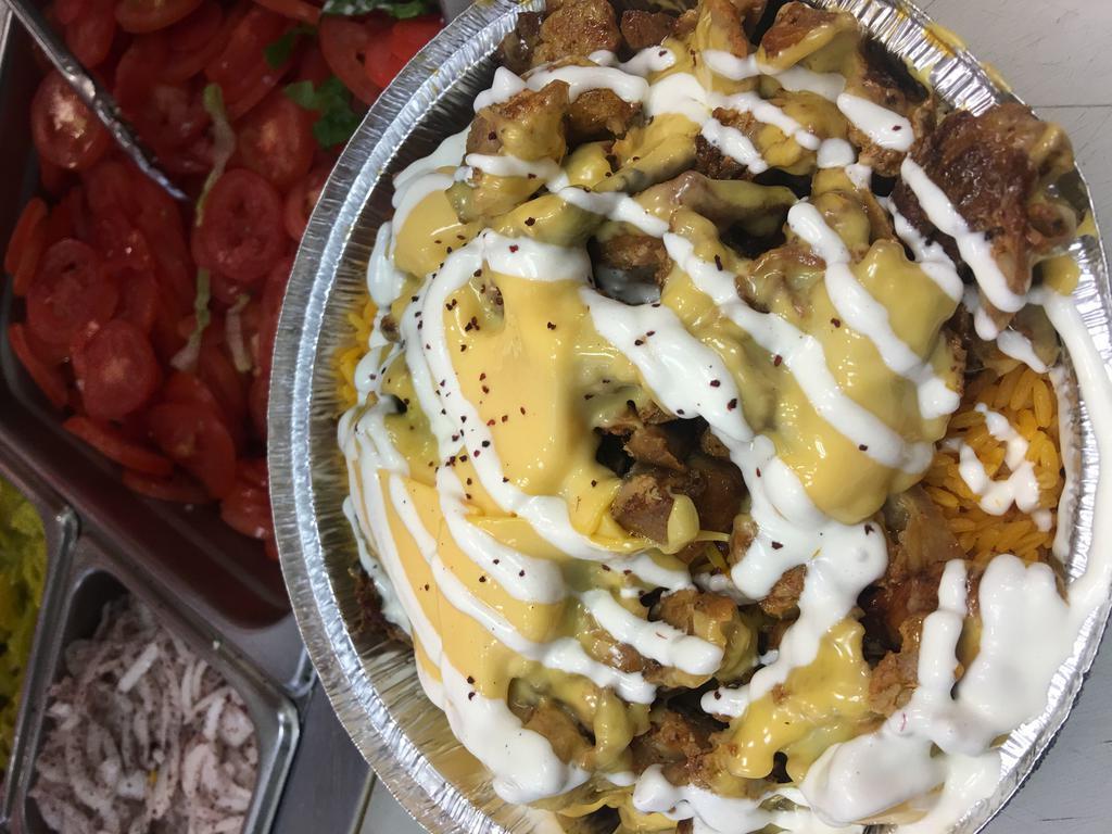 Chicken Philly Cheese Large Bowl · Thinly sliced, flame roasted chicken onion, green peppers, cheese and garlic sauce over rice or fries. Served with pita. (Doesn’t come with salad)