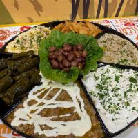 Sampler Tray · Includes hummus, baba ghanouj (roasted and mashed eggplant dip), dolmas (grape leaves stuffe...