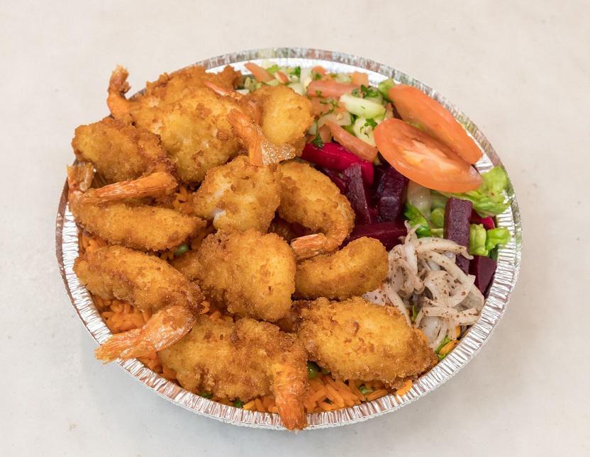 Fried Shrimp over Rice and Salad · Breaded panko shrimp served over rice and salad.