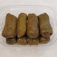 Dolma · Eight grape leaves stuffed with white rice.