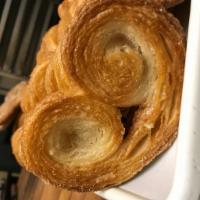 2 Elephant Ears · French puff pastry folded and baked with a light sugar coating.  It resembles the form of an...