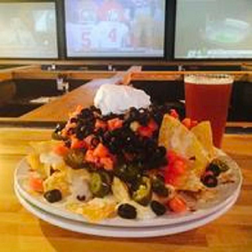 Macho Nacho · Fajita chicken, 3 cheeses, tomatoes, black olives, sour cream and jalapenos. Served with a side of salsa.