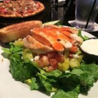 Buffalo Chicken Salad · Grilled chicken tossed in Buffalo sauce, romaine, pepperoncini, tomatoes, cucumbers, crumble...