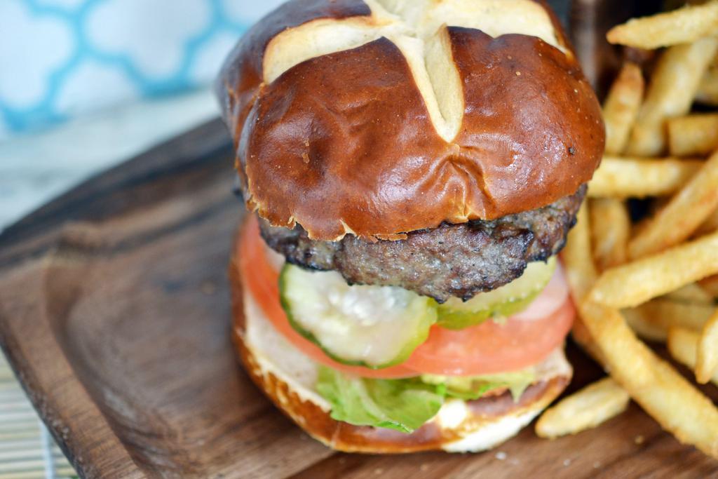 Classic Burger · Tomato, onion, lettuce and pickles. Our 100% fresh (never frozen) antibiotic, grass-fed beef perfectly grilled and served on a delicious pretzel bun.
