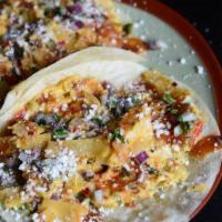 MIGAS TACO · eggs and house sofrito scrambled with fried tortilla strips, salsa quemada, avocado crema, q...
