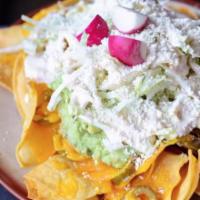 VICTORY NACHOS · House corn tortilla chips, pickled jalapeños, avocado and buttermilk crema with melted longh...