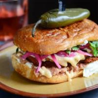 TORTA MILANESA · Fried pork cutlet, refried beans, grilled pineapple, pickled onions, Oaxacan cheese, cilantr...