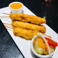 Fried Chicken Satay on Skewers · Batter Fried Traditional curry-coconut chicken skewers with peanut sauce and Asian pickle.