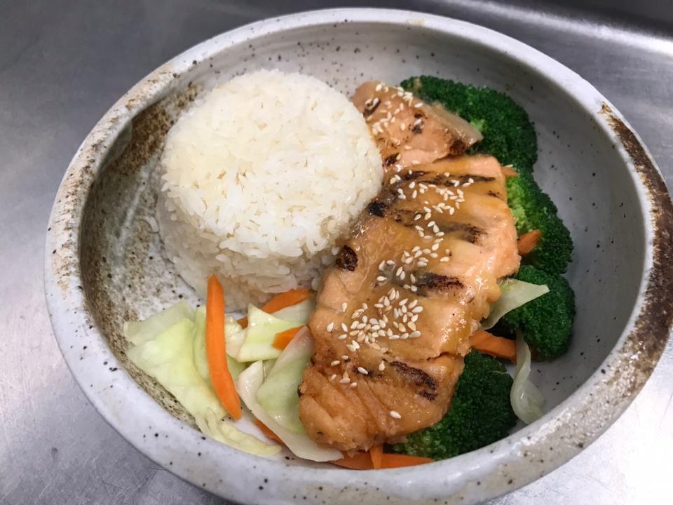 Grilled Miso Salmon Rice Bowl · Miso-marinated grilled salmon served with white rice, Broccoli, Carrot, Cabbage, Teriyaki sauce.