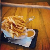 Coconut Curry Fries · Crispy fries with Massaman curry dip.