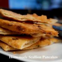 Scallion Pancake · Handcrated, deep-fried dough flavored with scallions and served with a ginger-soy sauce.