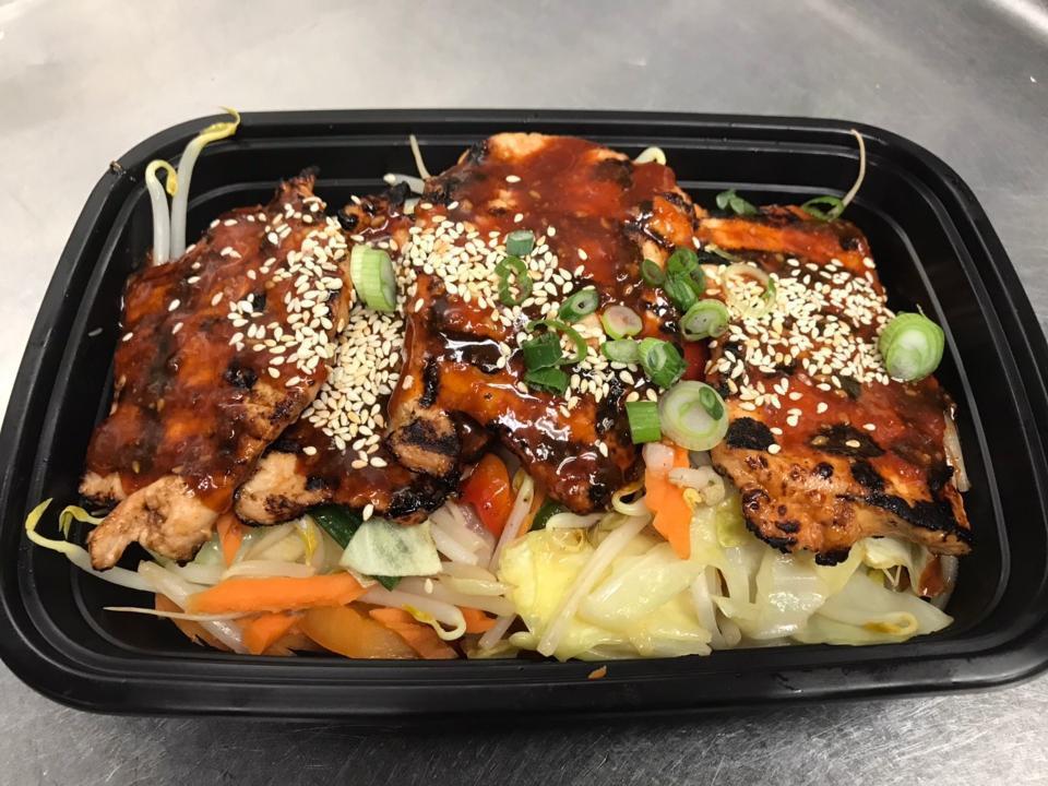 Sizzling Spicy Pork · Sliced pork marinated with Korean pear, white onions, ginger, garlic,hot pepper paste, sesame oil, sesame seeds, soy sauce, brown sugar, honey. Served with cabbage, bean sprouts, carrots and scallions on a hot pan.