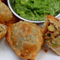 Vegetable Samosas · 2 samosas filled with seasoned potatoes and peas and wrapped in a light pastry.