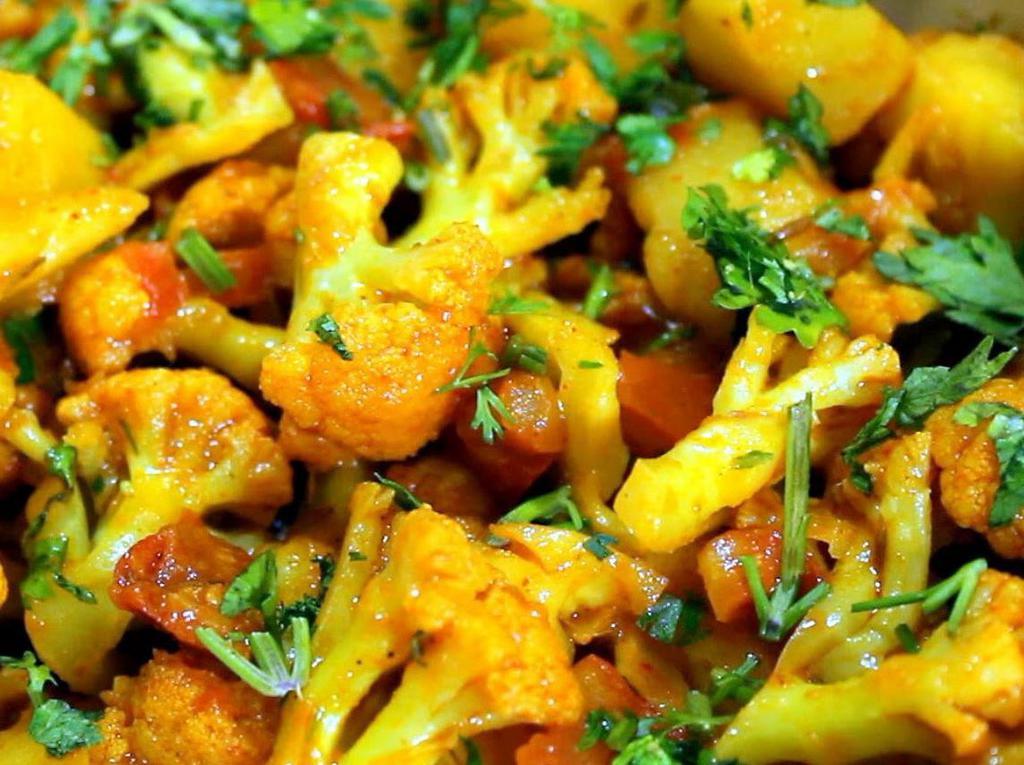 Aloo Gobi · Vegan. Gluten Free. Locally grown cauliflower and potatoes cooked in ginger, turmeric and tomato masala