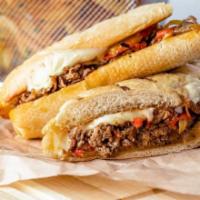 Cheese Steak Sandwich · Herb-Marinated Beef, Peppers, Onions, American Cheese